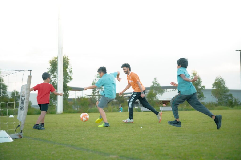 Kids playing a small-sided soccer game at an after-school session